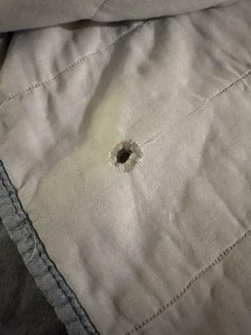 Bullet hole on bed linen?