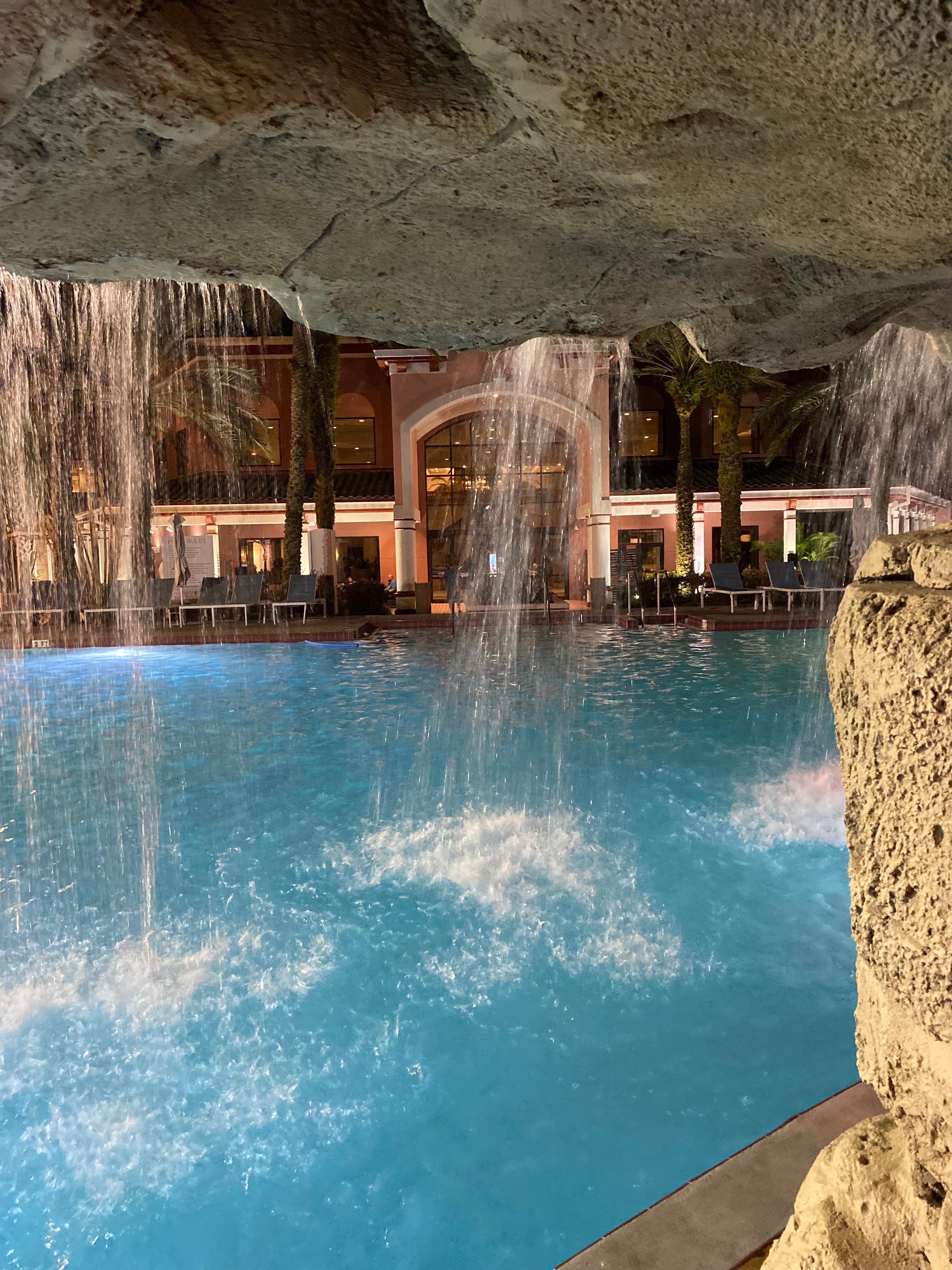 Captured the resort glowing at night through the waterfall—like looking through a curtain of water at Caribe Royale Orlando.