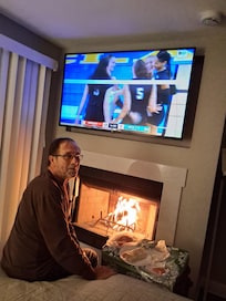 Watching Nebraska Volleyball in our room with a cozy fire!