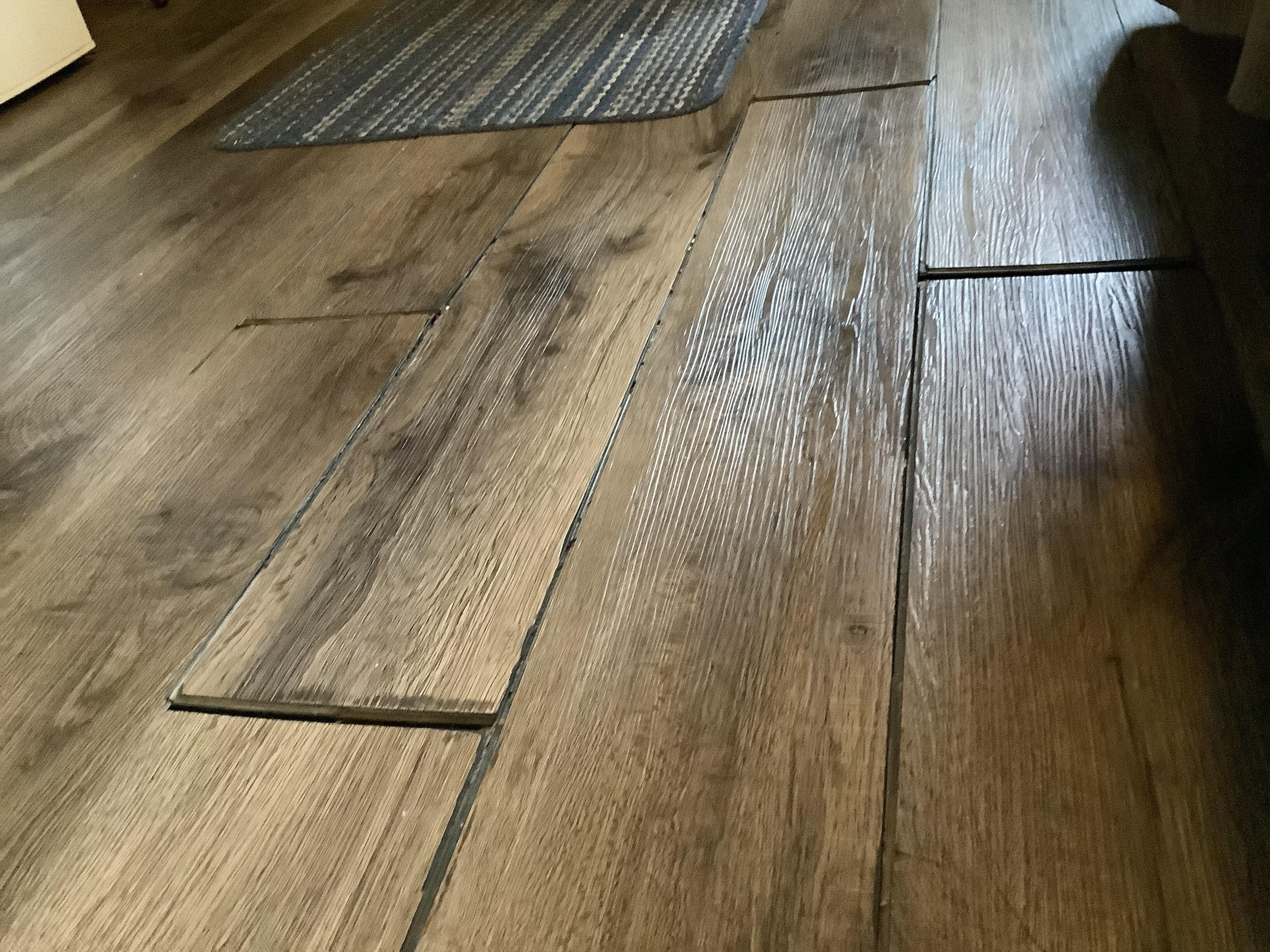 Dirty floor planks sticking up to trip on