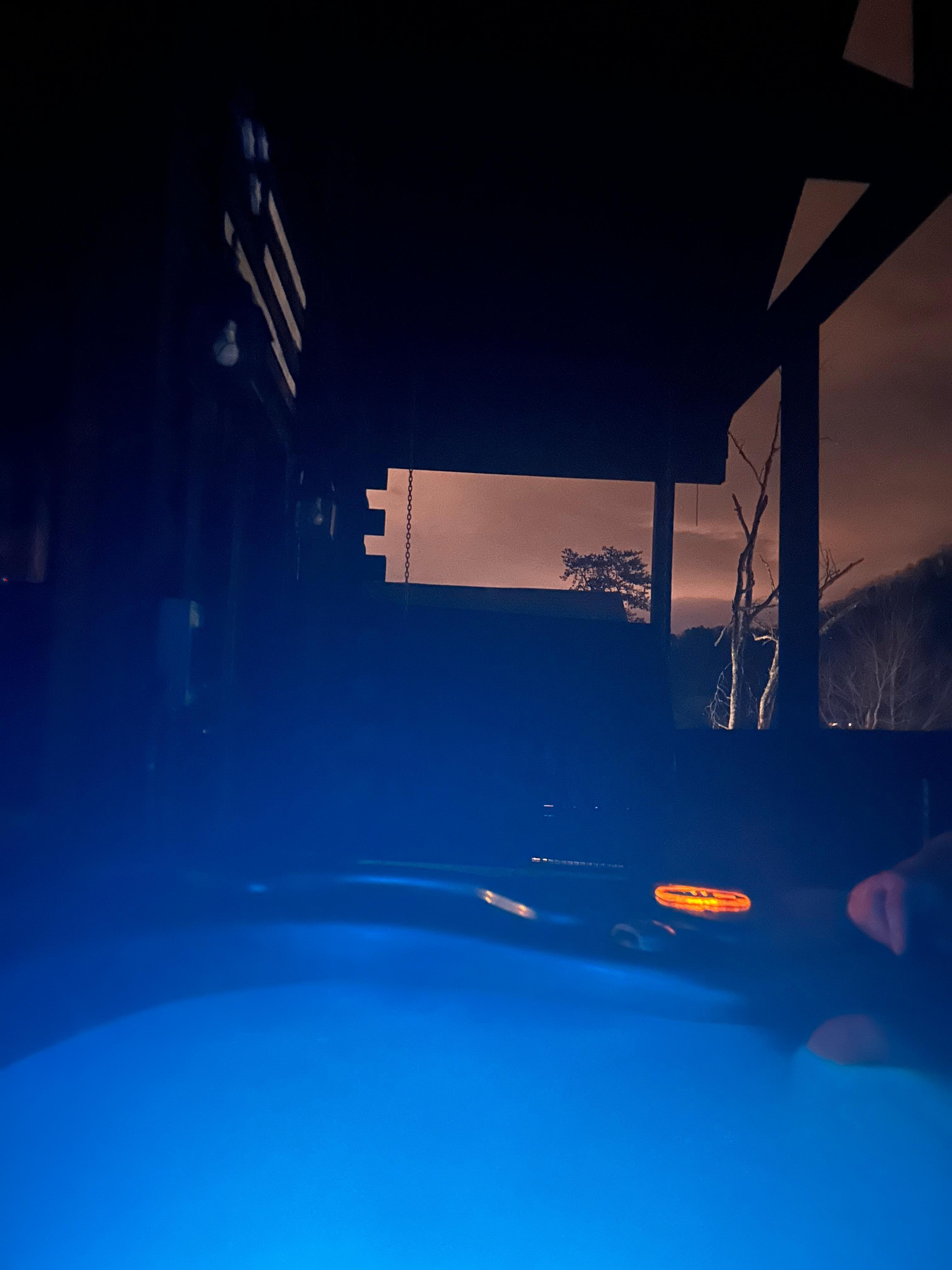 Hot tub at night. The colors change & u can see the swing in the background.