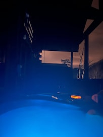 Hot tub at night. The colors change & u can see the swing in the background.