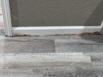 More water damage down stairs along the baseboards