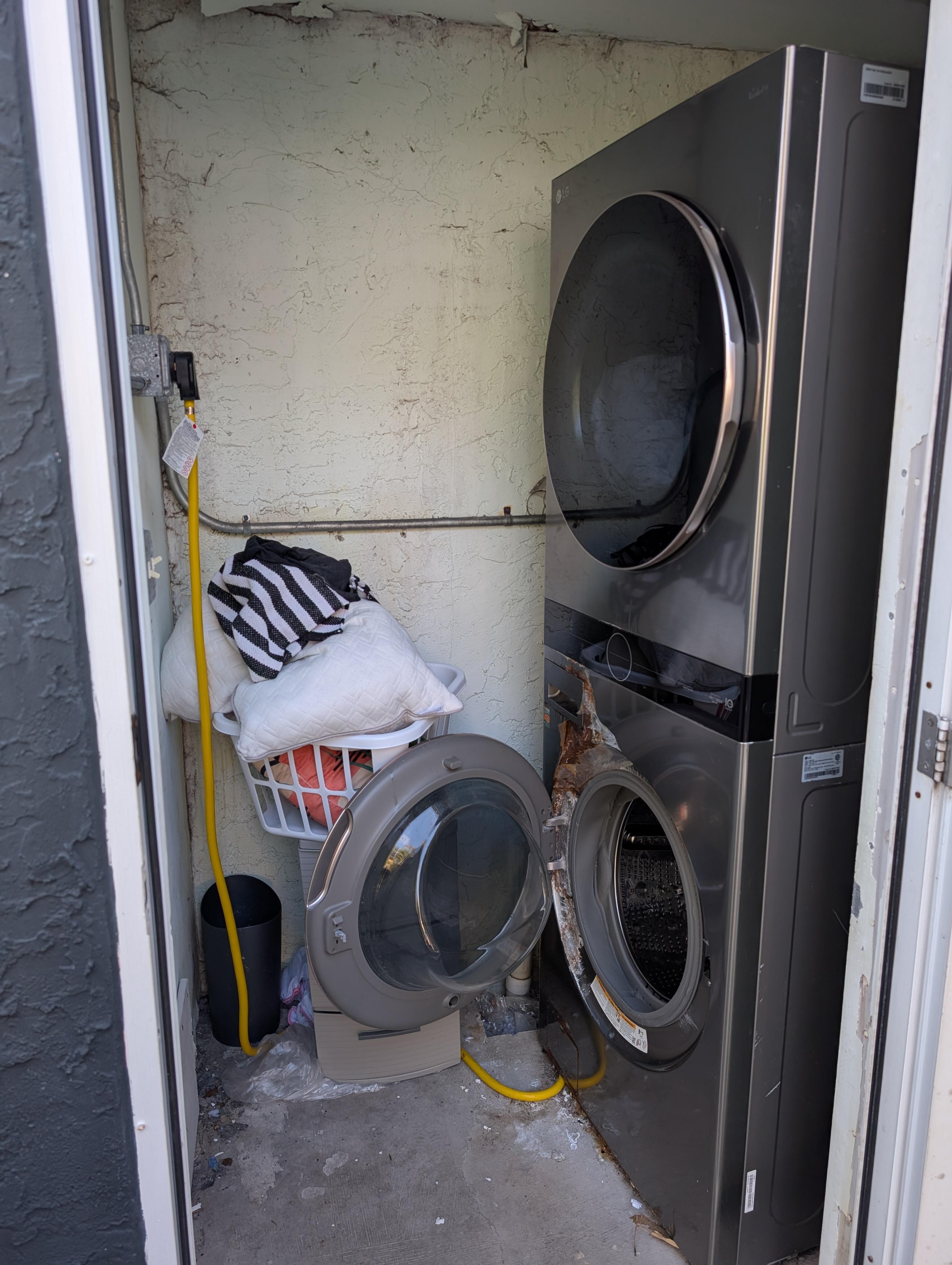 Washer & dryer are outside the suite. The washer on the bottom is rusted inside the door & out.