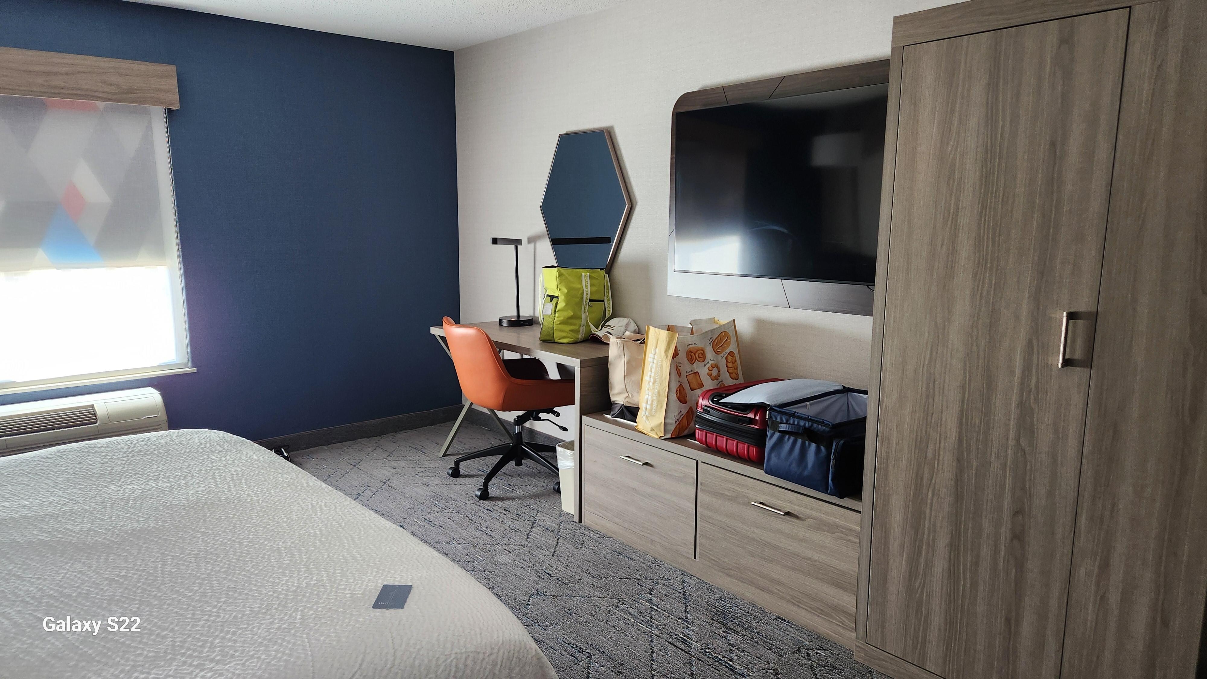 When entering the room, there was a large bathroom on the left side and along the wall, A really nice furniture unit VS dressers and drawers. Bright room and comfortable colors.
