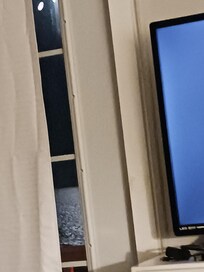 View from bed, overlooking ocean at night.