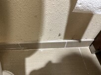 Black marks on bathroom wall