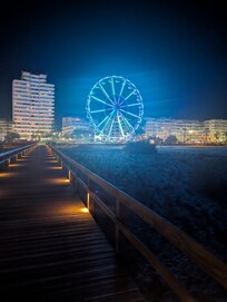 Night view of Ferris wheel from the beach