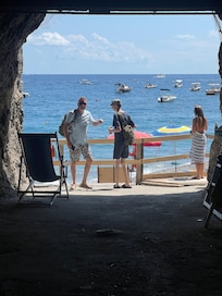 You take 2 elevators to the beach thru caves/tunnels. Towels, cars and umbrellas are provided with a snack bar where you can get food for additional charges.