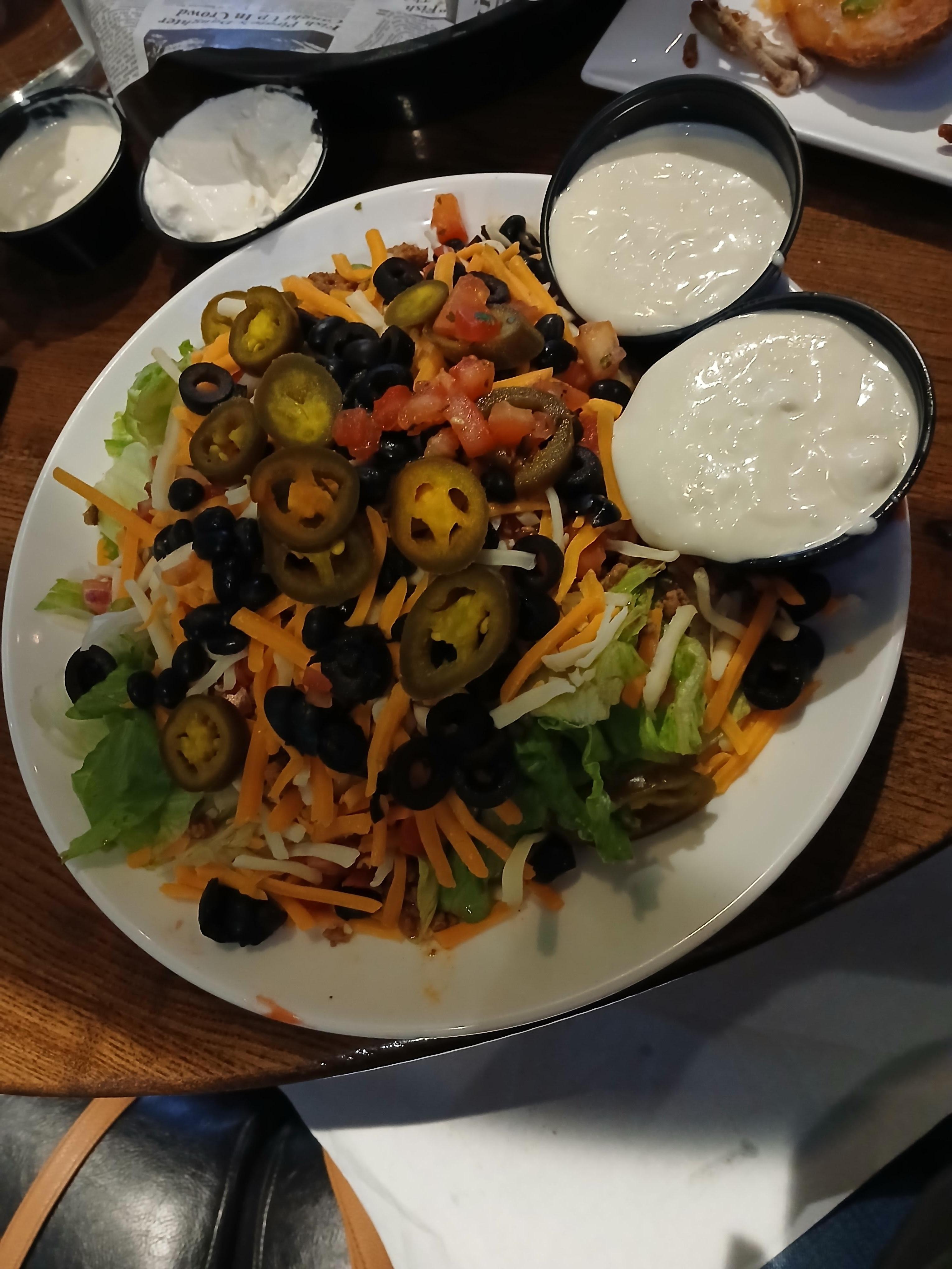 Taco salad with a side of dressing, I also had a large appetizer with a variety of things to eat.