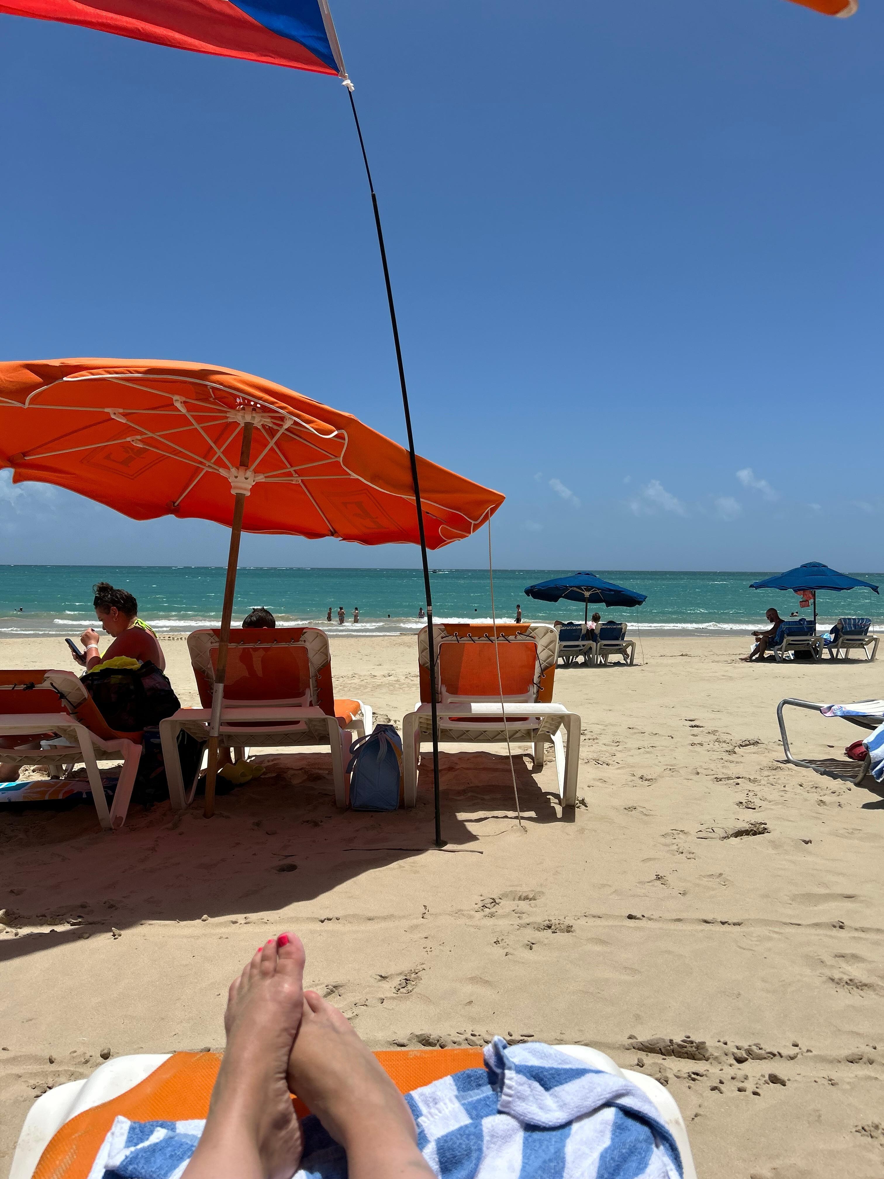 Beach with hotel provided towels, umbrellas and chairs