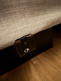 Sharp rusted metal slats protruding from under the bed. The mattress is intended to sit within these, but the mattress is too small, leaving three of these sharp rusty hooks at ankle height on either side of the bed.