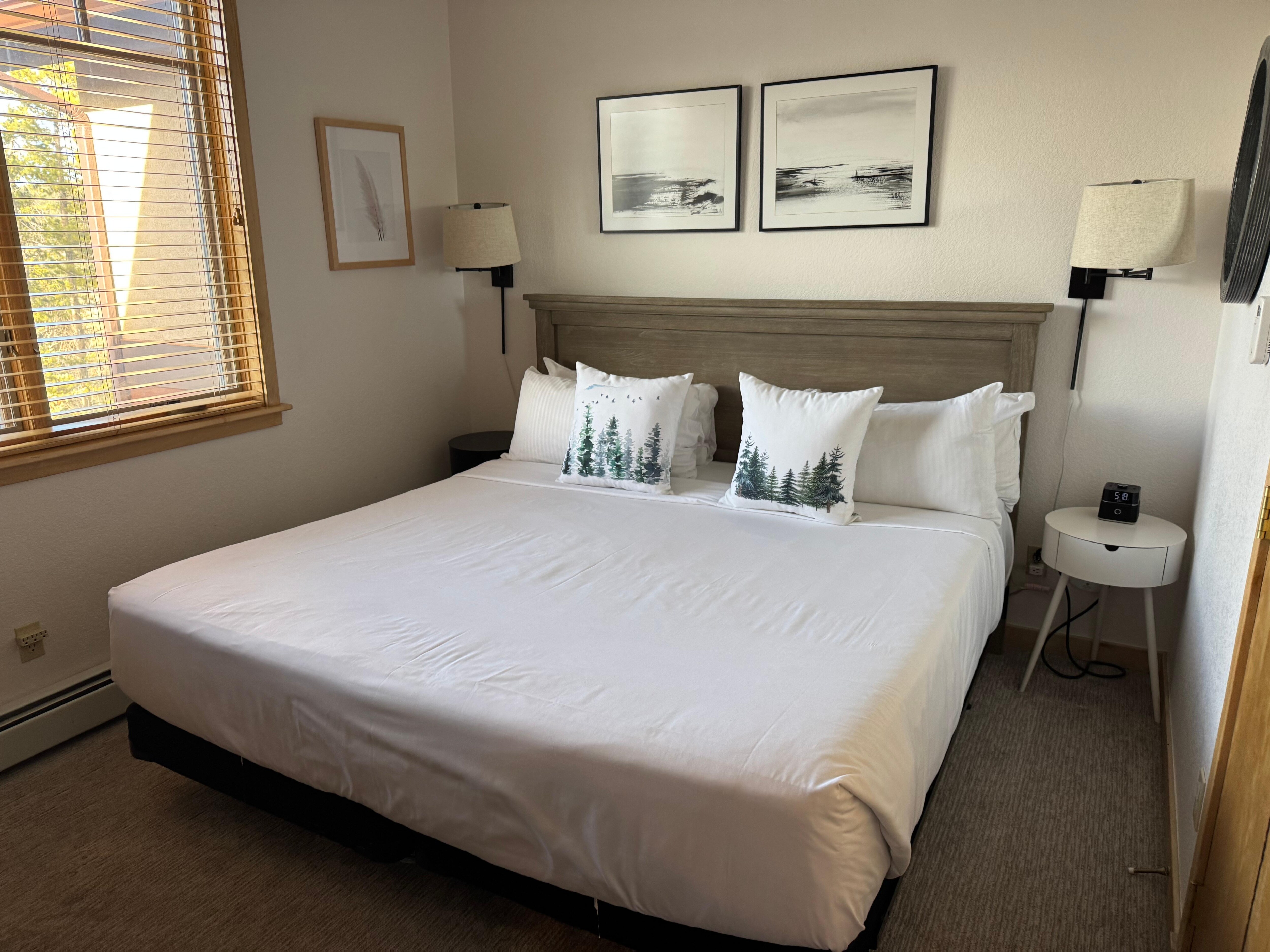 Bedroom with comfy king bed & beautiful natural light. Also had ceiling fan, dimmable overhead light, and bedside sconces. 