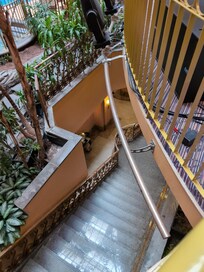 Looking down at the lobby, stairs up to the pool