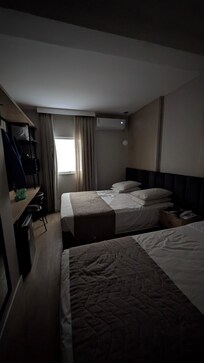 First room 119, dark with concrete building wall view at the window