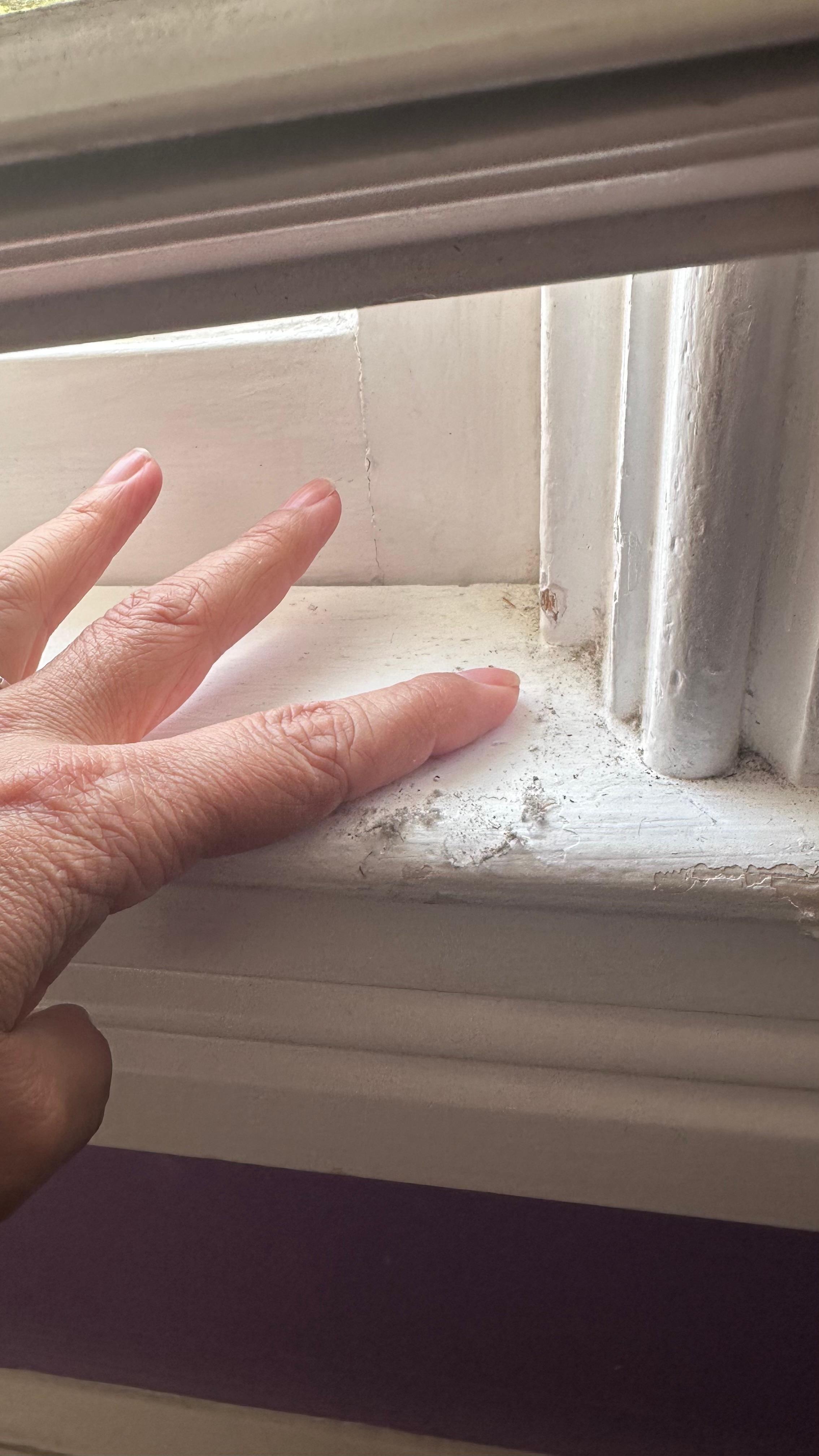 Dust buildup around the window frame and sill.