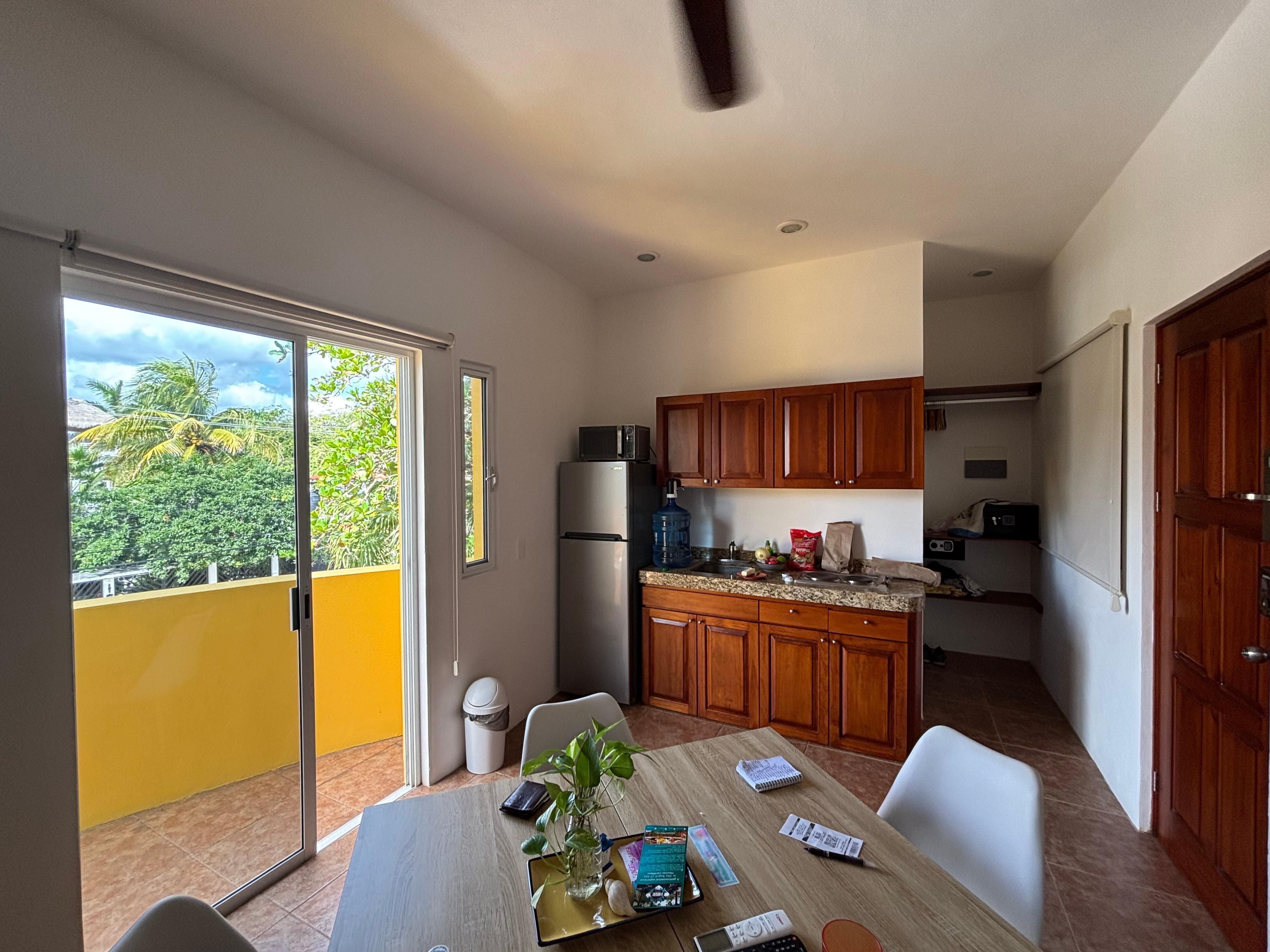 Kitchenette and slider out to balcony.