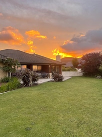 Flaming sunset looking back over house