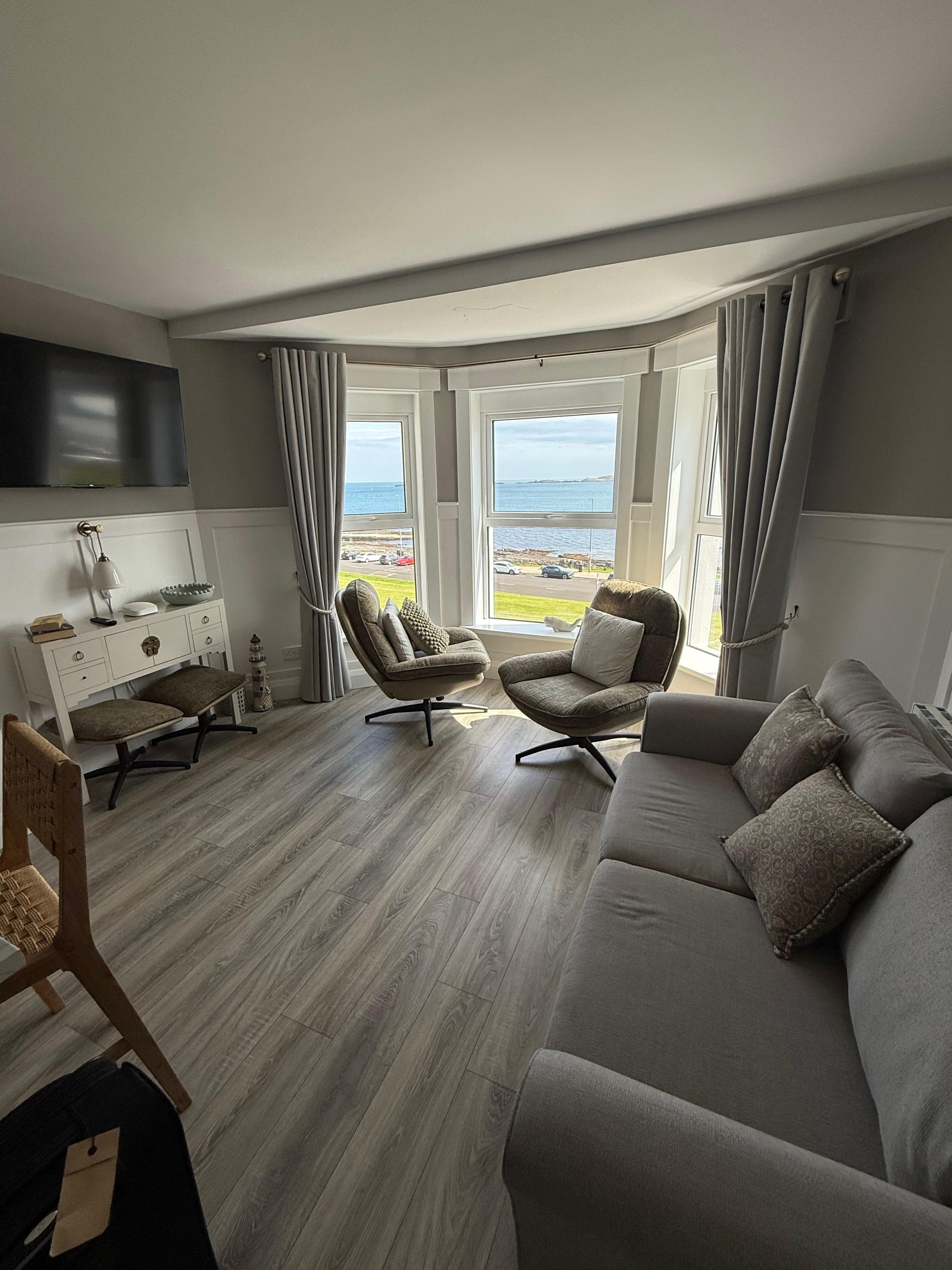 Open living room with two PERFECT chairs to take in the views.