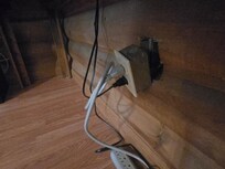 Exposed wires behind electrical outlet