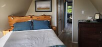 Bed facing the windows and the stars.