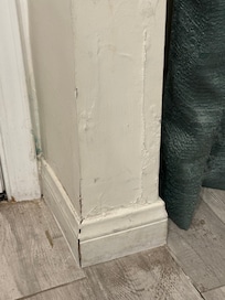 Significant wall/sheetrock damage in the living area.