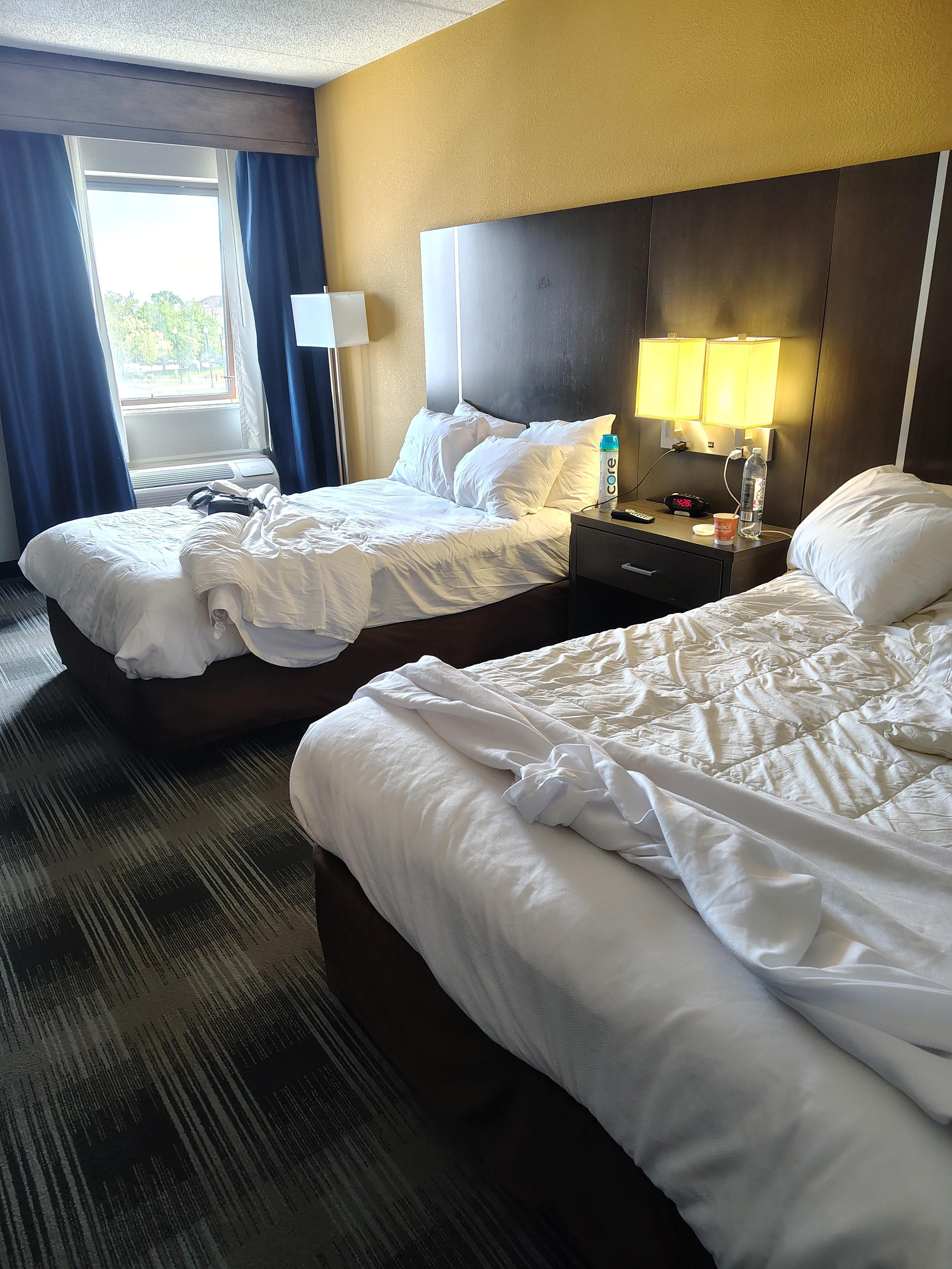 Wrinkled and possibly not clean bed sheets after just pulling down the blankets.