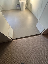 Trip hazard, tiles missing, gap in floor.