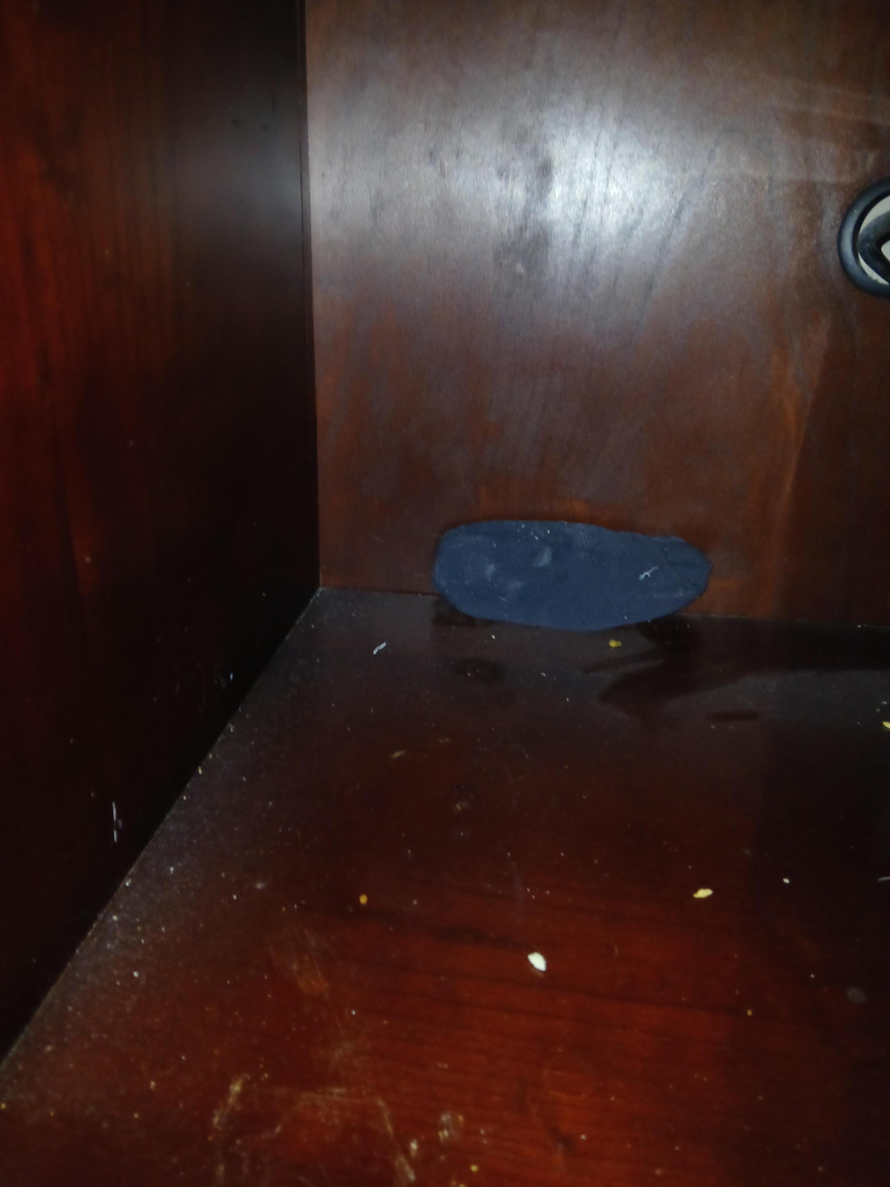 Sock and dirt behind microwave 