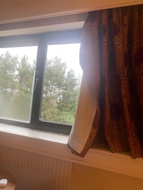 Curtain hanging off.