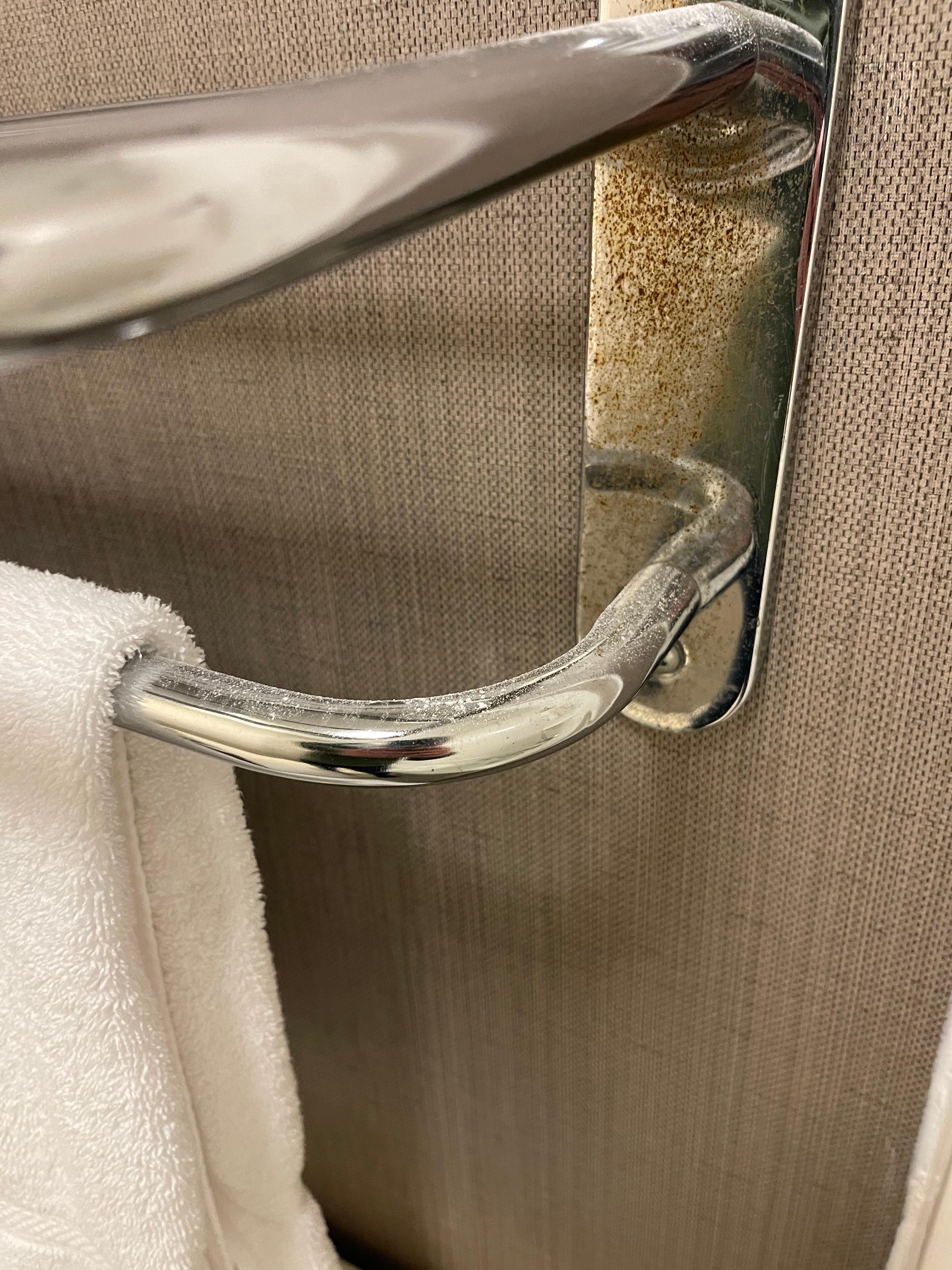 Drywall/plaster dust will on towel rack. 