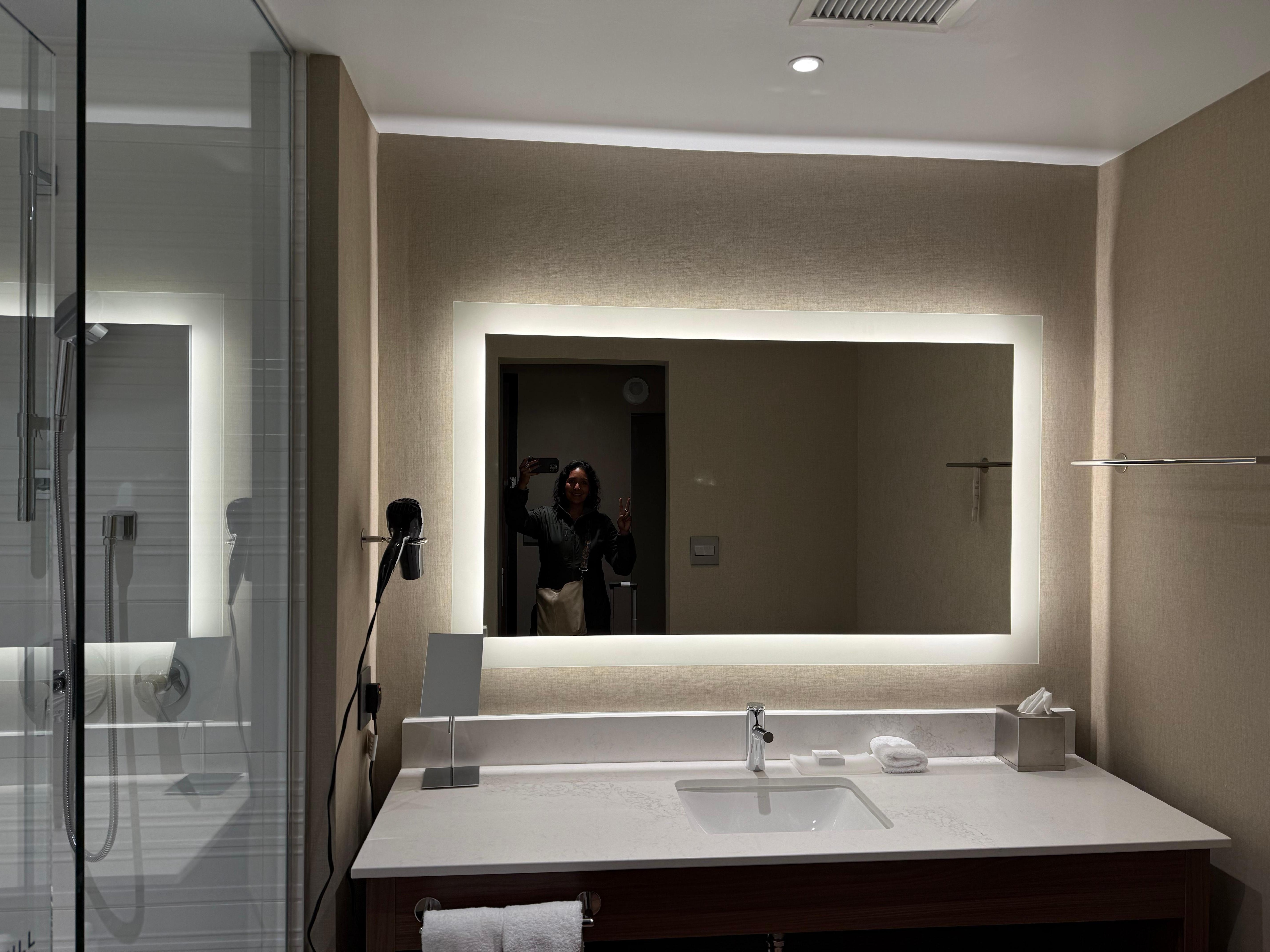 Spacious, clean bathroom with good lighting. 