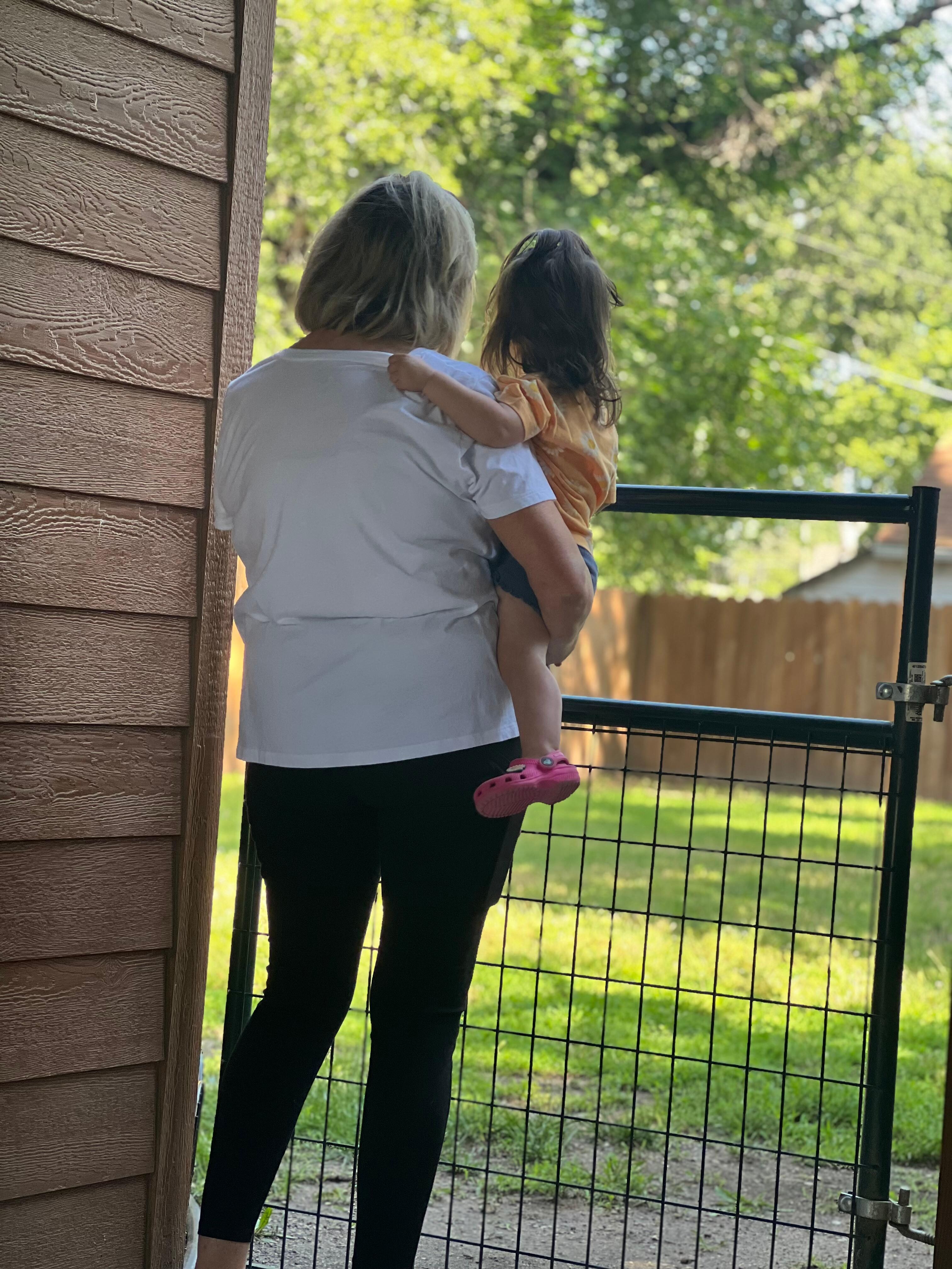 Holding my granddaughter. She loved the big backyard. She wasn’t staying with us as her parents live in the area. 