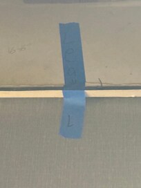 Blue tape all down hall to show where pipes leaked