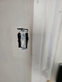 No cover light switch by door