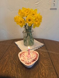 Picture of flowers placed in the room along with our one year anniversary cake.