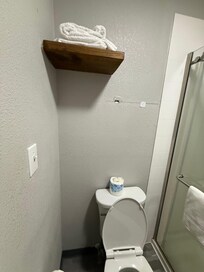 12” long black hair left on toilet under toilet paper. Holes in wall. One covered with duck tape