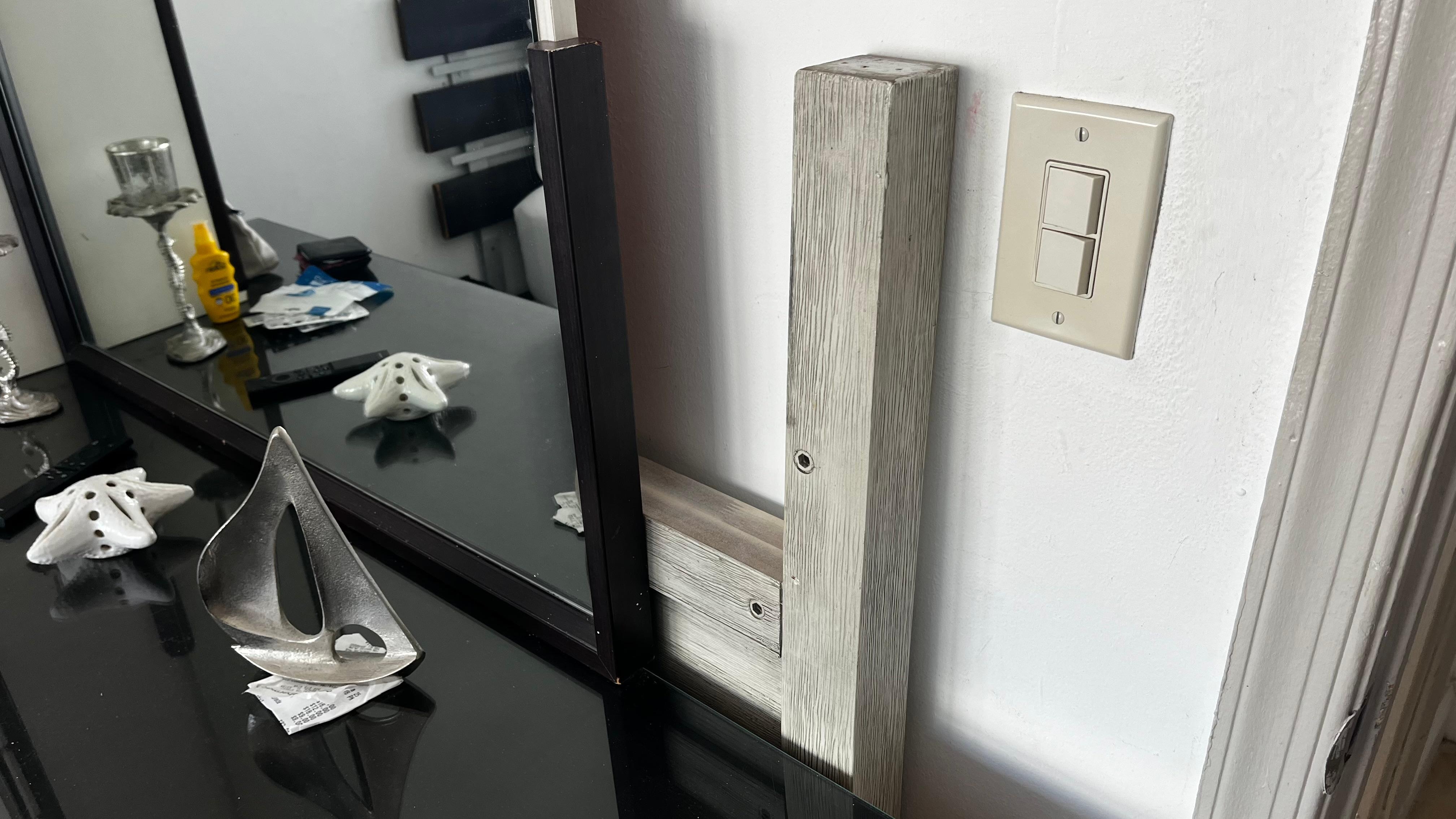 Old headboard tucked behind dresser 