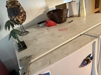On top of fridge.