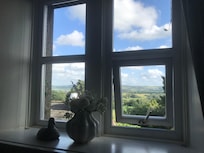 Two large windows in the four poster room with stunning views over the valley.