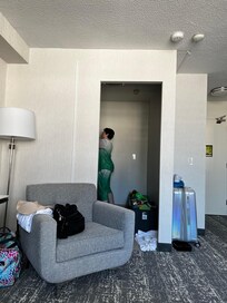 Putting away food in the cupboards.