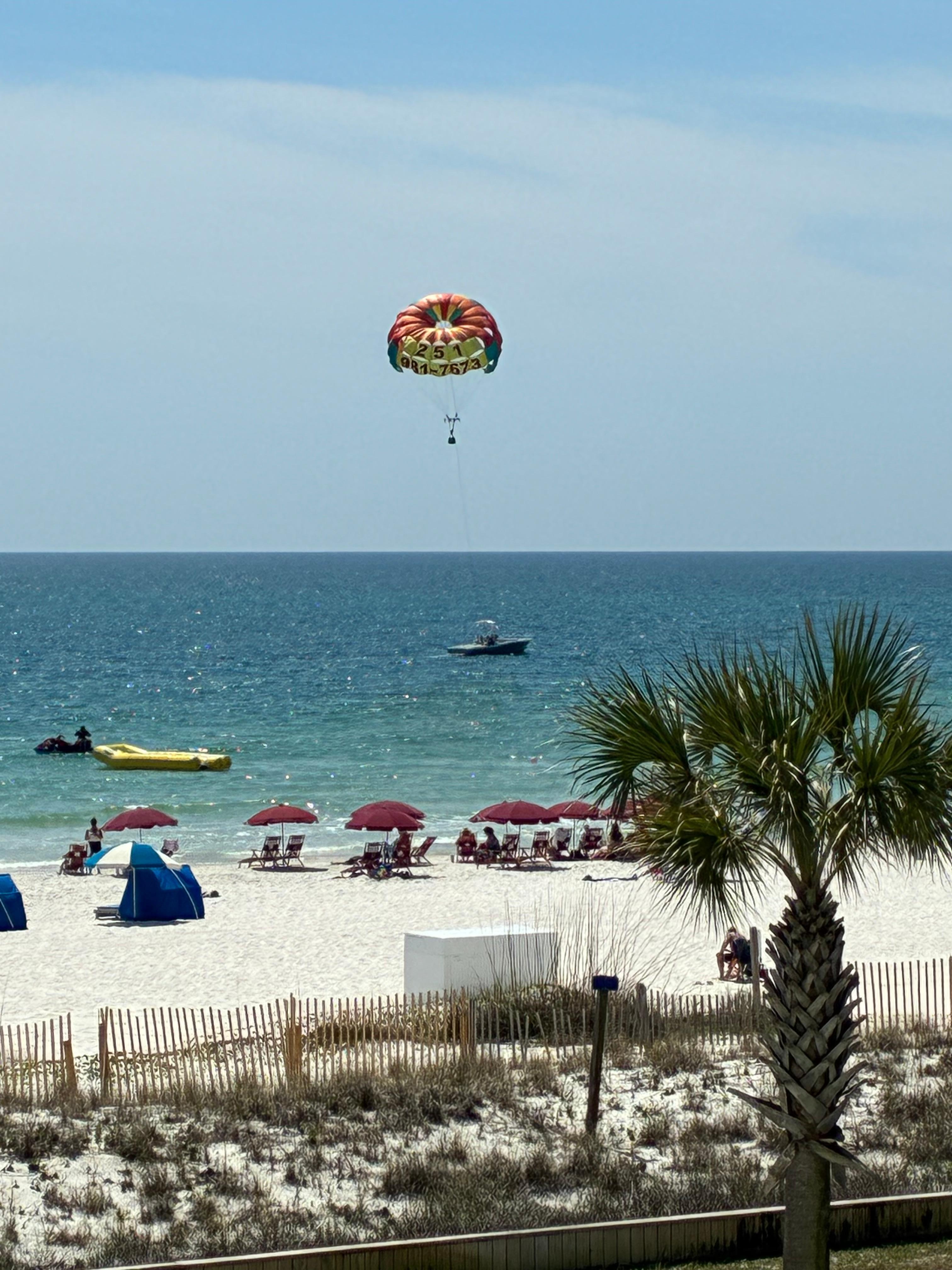 Enjoying watching parasailing from balcony 