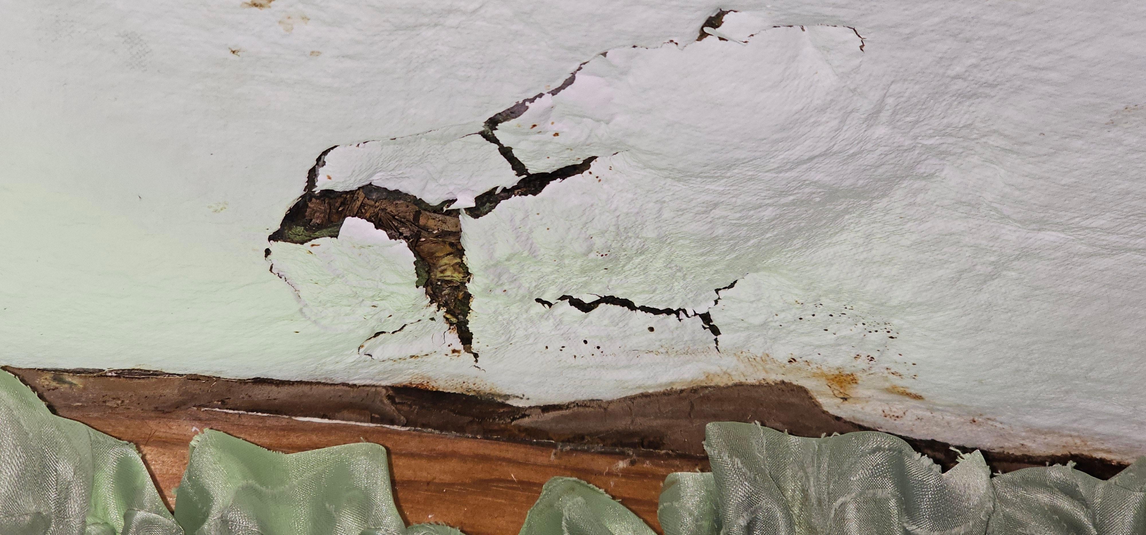 Hole in kitchen ceiling due to water damage 