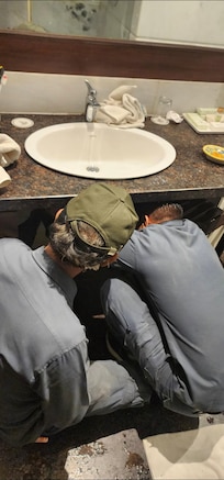 Technician working on fixing water problem