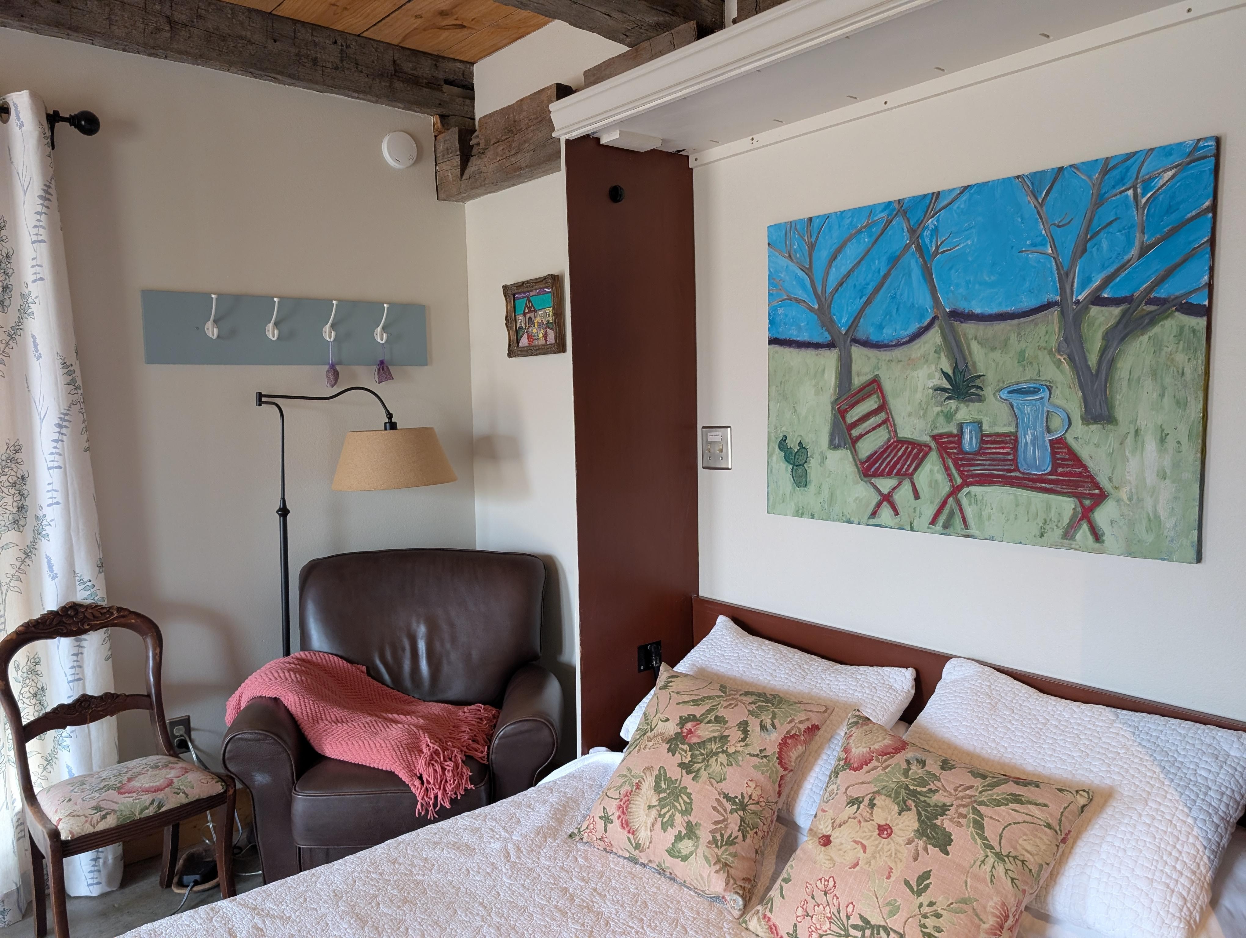 Comfy chair for reading and tv watching. Murphy Bed folds up for access to a drop down table.