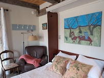 Comfy chair for reading and tv watching. Murphy Bed folds up for access to a drop down table.