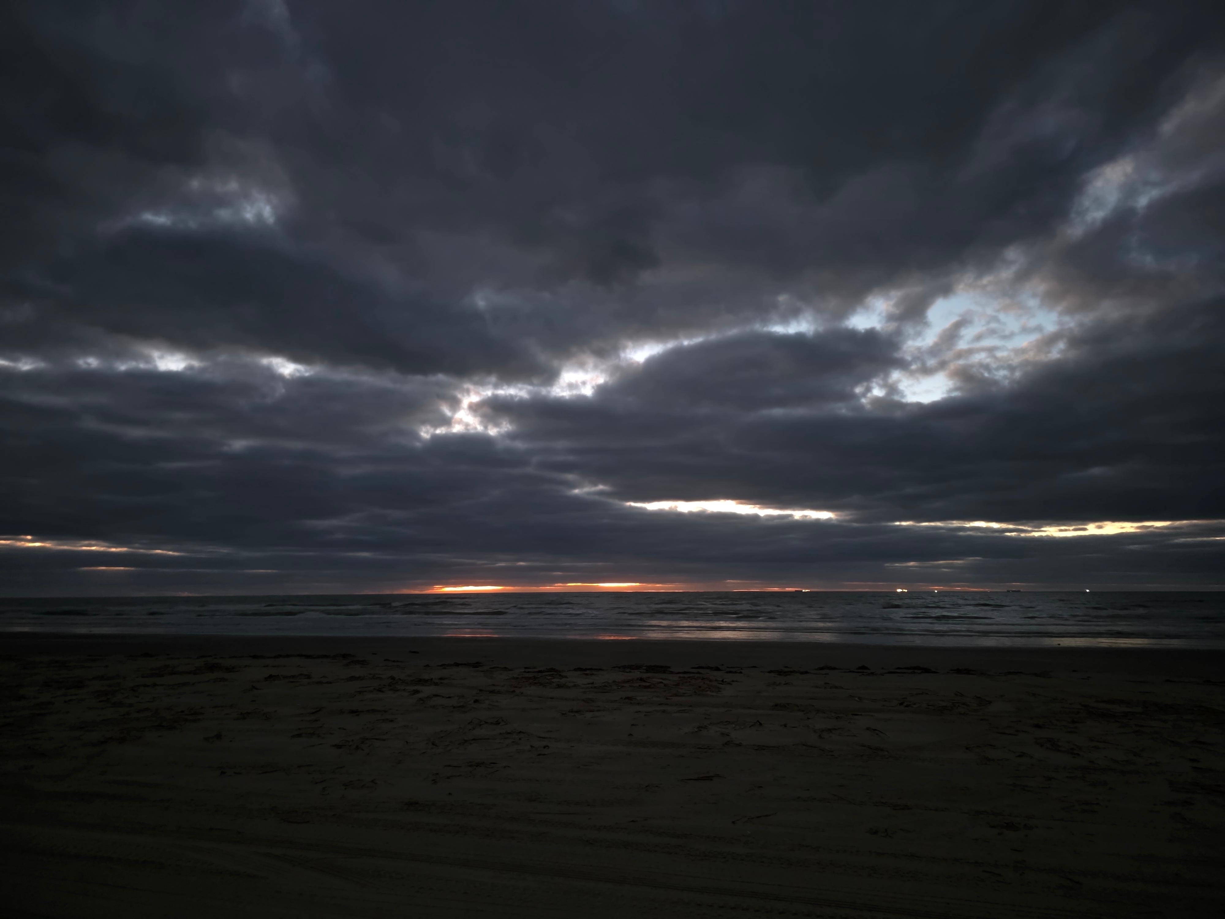 Lightning behind clouds standing on deck.