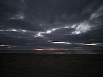 Lightning behind clouds standing on deck.