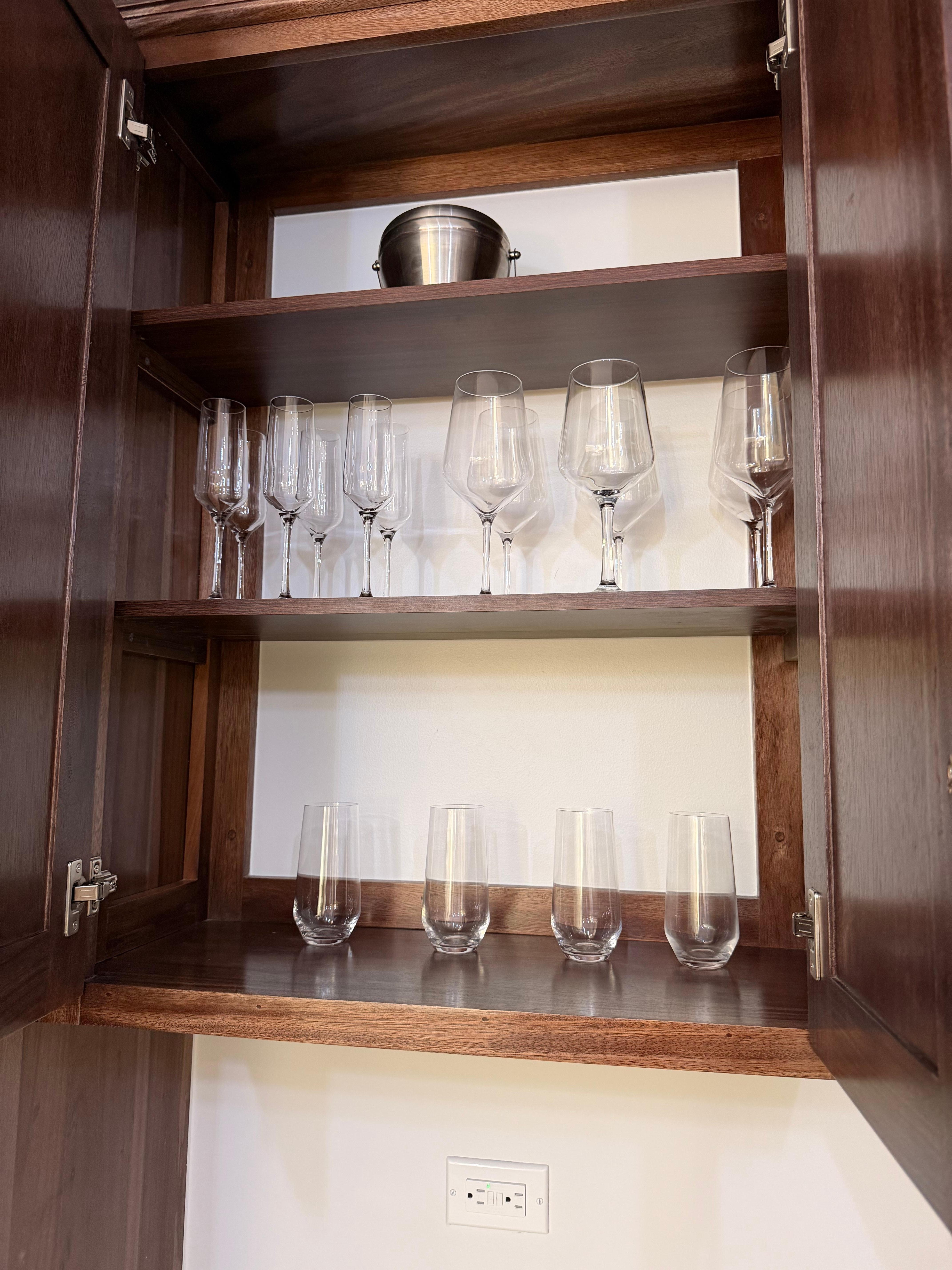 Nice supply of glasses and dishes. 