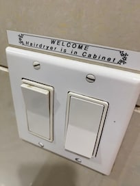 Dirty light switch that says where the hair drier is...